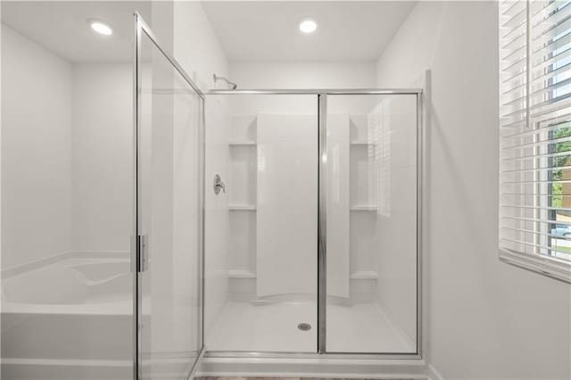 bathroom with a shower stall and recessed lighting