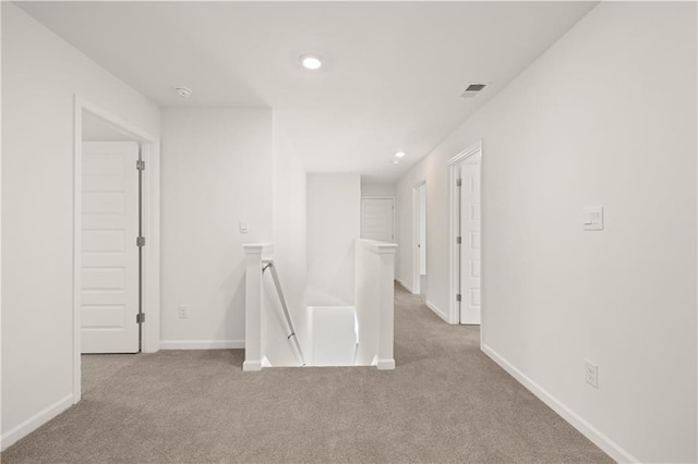 spare room with baseboards, visible vents, and carpet floors