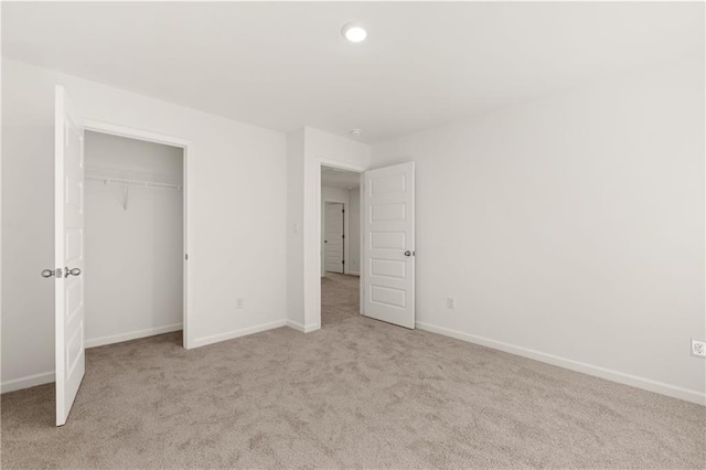unfurnished bedroom with baseboards and light colored carpet