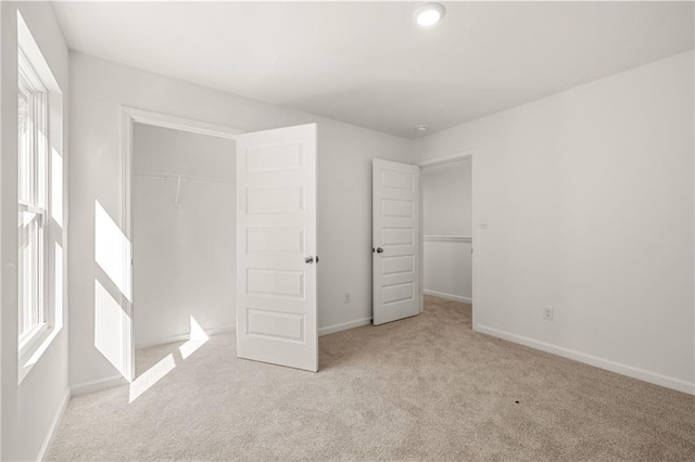 unfurnished bedroom with a closet, carpet flooring, and baseboards