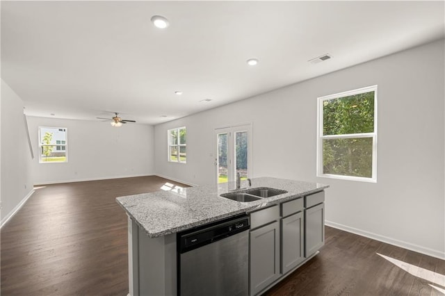 kitchen featuring visible vents, dark wood-type flooring, a sink, gray cabinets, and stainless steel dishwasher