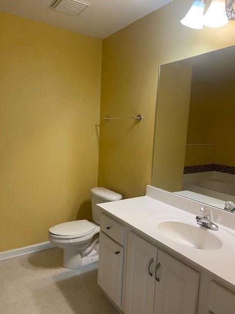 bathroom with baseboards, visible vents, vanity, and toilet