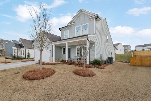 view of front facade featuring covered porch, central air condition unit, and a front lawn