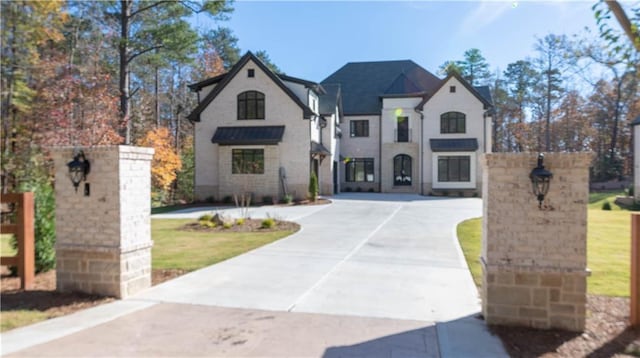 french country style house featuring driveway and a front lawn