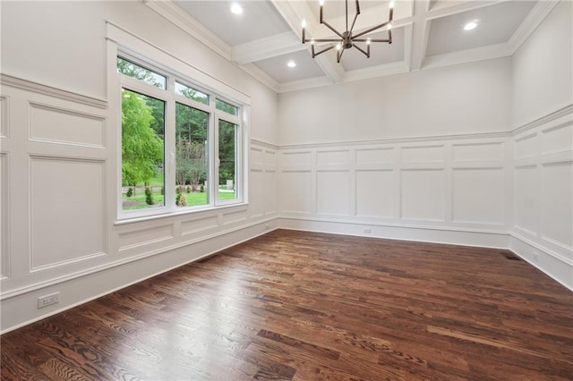 empty room featuring dark wood finished floors, a chandelier, a decorative wall, and beam ceiling