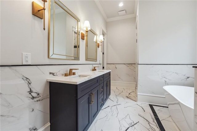 full bath with a wainscoted wall, a sink, a freestanding bath, marble finish floor, and double vanity