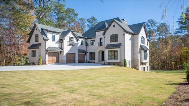 view of front facade with a front yard, a standing seam roof, and metal roof