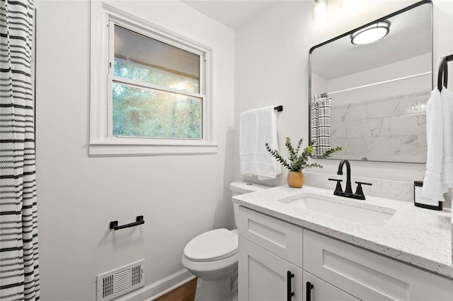 bathroom with visible vents, vanity, toilet, baseboards, and a shower with curtain