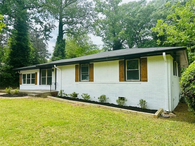 ranch-style house with brick siding and a front yard