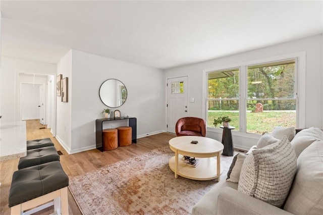 living room featuring light wood-style floors and baseboards