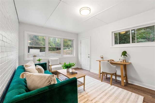 living area featuring baseboards and wood finished floors