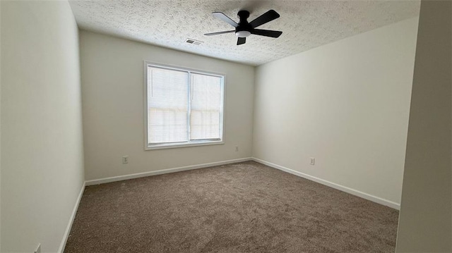 carpeted empty room with a ceiling fan, baseboards, visible vents, and a textured ceiling