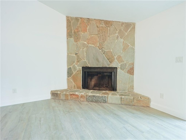 interior details with hardwood / wood-style floors and a fireplace