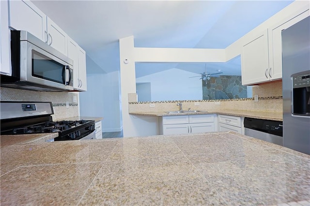 kitchen featuring sink, white cabinetry, tasteful backsplash, ceiling fan, and stainless steel appliances