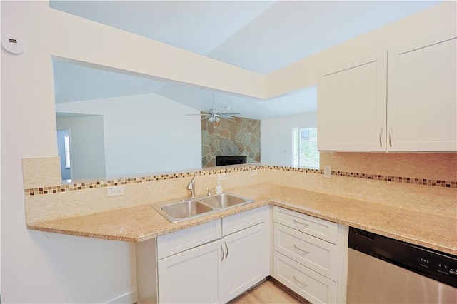 kitchen featuring sink, tasteful backsplash, dishwasher, ceiling fan, and white cabinets