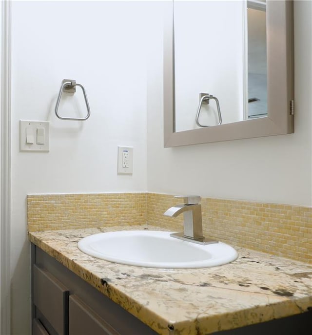 bathroom with vanity and decorative backsplash