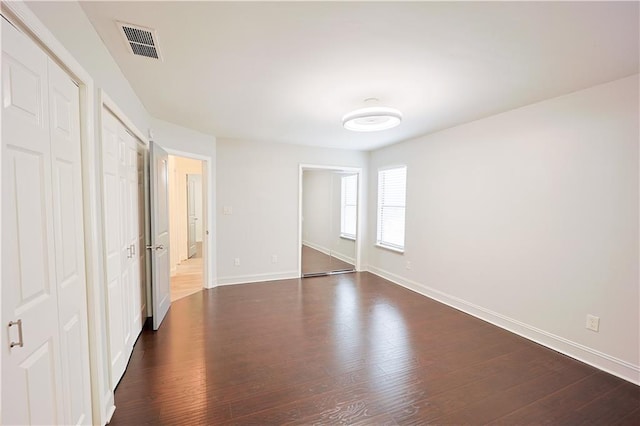 unfurnished bedroom featuring dark wood-type flooring