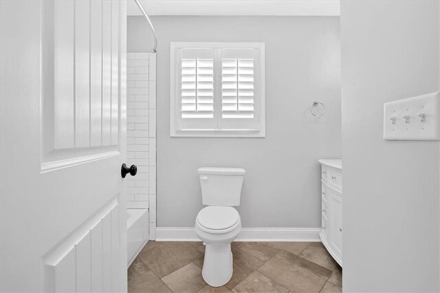 full bath with toilet, baseboards, shower / bathing tub combination, and vanity