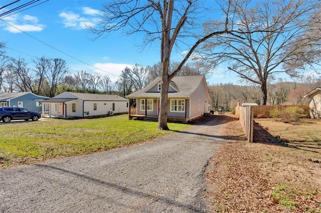 bungalow-style house with a front yard and driveway