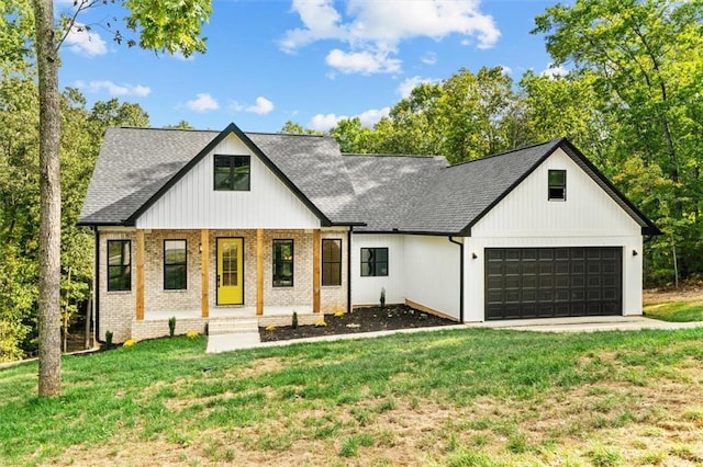 modern inspired farmhouse with a front yard and a garage