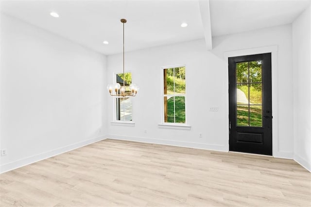 entrance foyer featuring beam ceiling, a notable chandelier, and light hardwood / wood-style floors