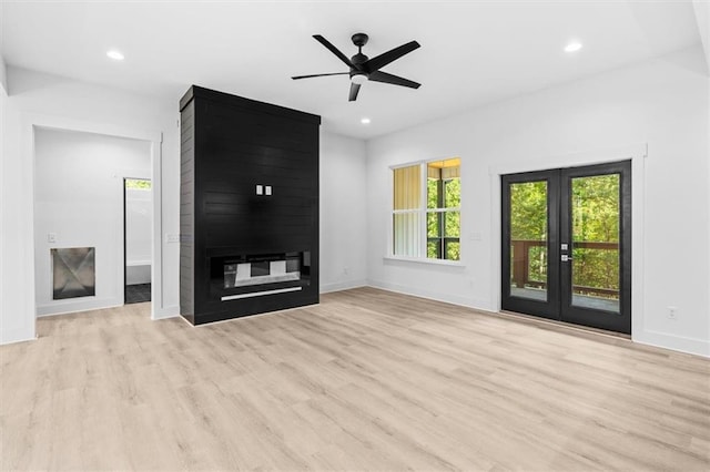 unfurnished living room featuring french doors, light wood-type flooring, and ceiling fan