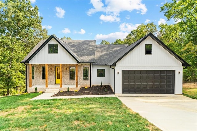 modern inspired farmhouse with covered porch, a front lawn, and a garage