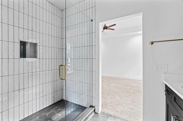 bathroom with vanity, ceiling fan, tile patterned flooring, and walk in shower