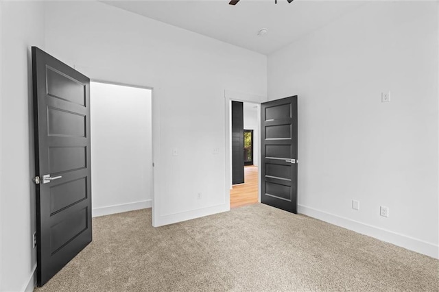 unfurnished bedroom featuring carpet flooring and ceiling fan