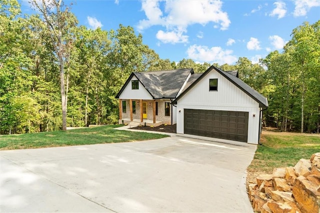 modern farmhouse style home featuring a front yard and a garage