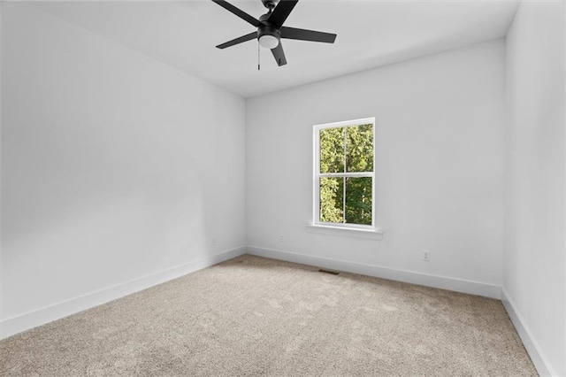 unfurnished room featuring ceiling fan and carpet