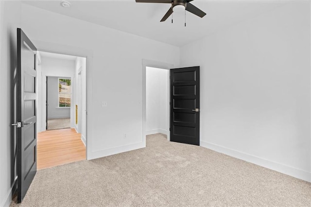 unfurnished bedroom with light carpet and ceiling fan