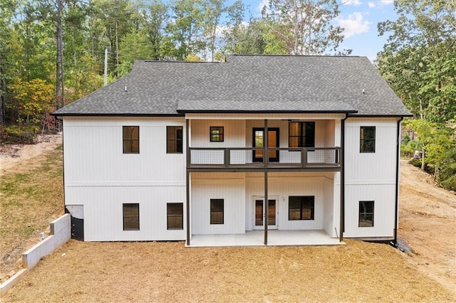 rear view of house with a patio area and a balcony