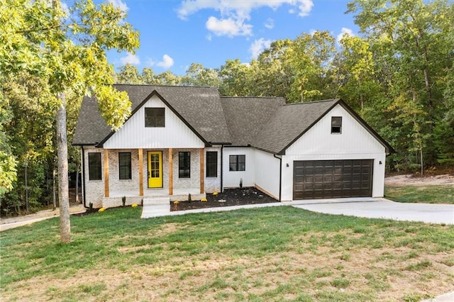 modern farmhouse featuring a front yard and a garage