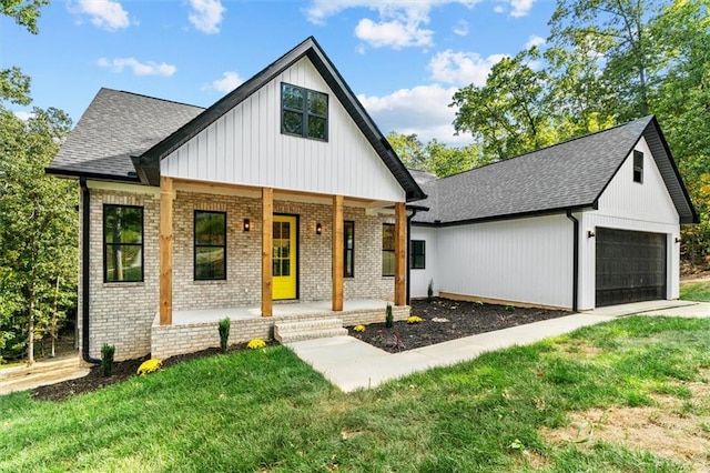 modern farmhouse style home with covered porch and a front lawn