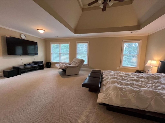 bedroom featuring carpet flooring, a tray ceiling, ceiling fan, and ornamental molding