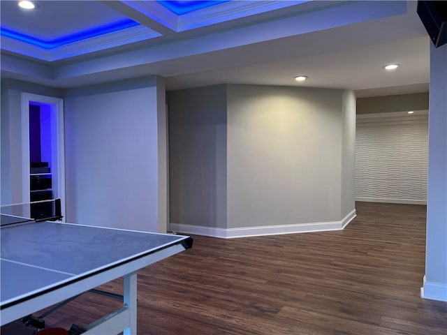 playroom with beam ceiling, dark hardwood / wood-style flooring, crown molding, and coffered ceiling