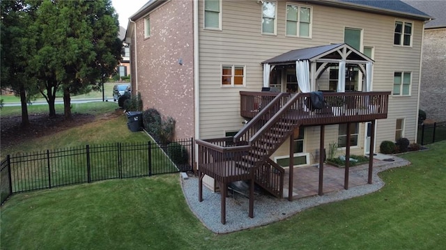 rear view of property with a lawn and a deck