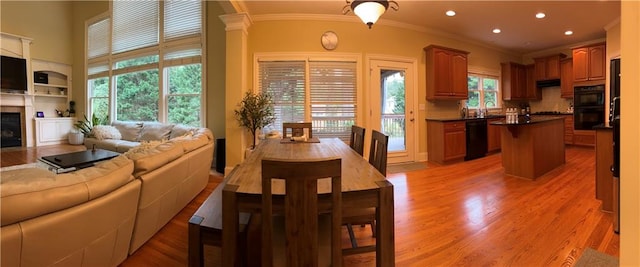 dining area featuring light hardwood / wood-style flooring and ornamental molding