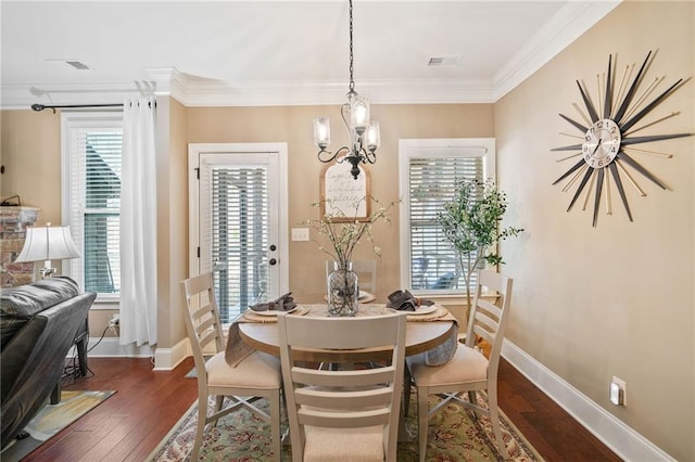 dining room with crown molding, dark wood-type flooring, and a notable chandelier