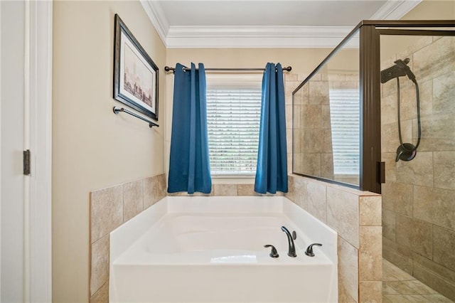 bathroom with ornamental molding and shower with separate bathtub