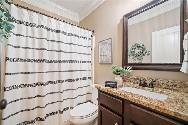 bathroom with ornamental molding, vanity, and toilet