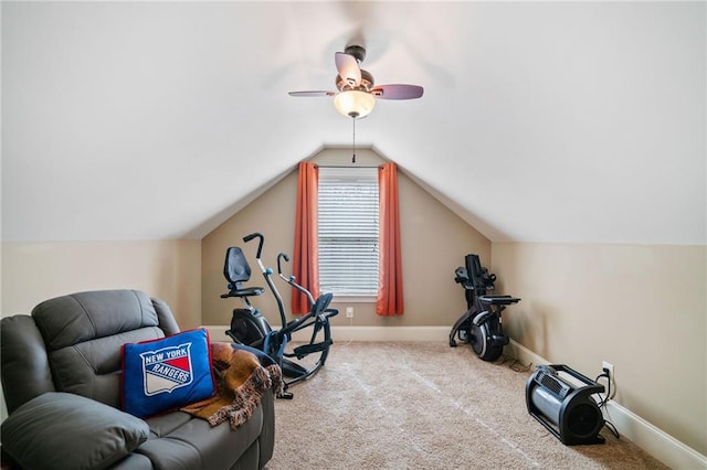 exercise room featuring ceiling fan, vaulted ceiling, and light colored carpet