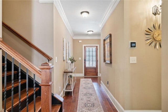 entryway with dark hardwood / wood-style flooring and ornamental molding