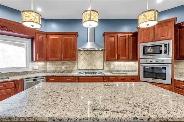 1580 Loving Rd, Morganton, GA 30560 - kitchen featuring light stone countertops, a center island, wall chimney exhaust hood, appliances with stainless steel finishes, and decorative light fixtures