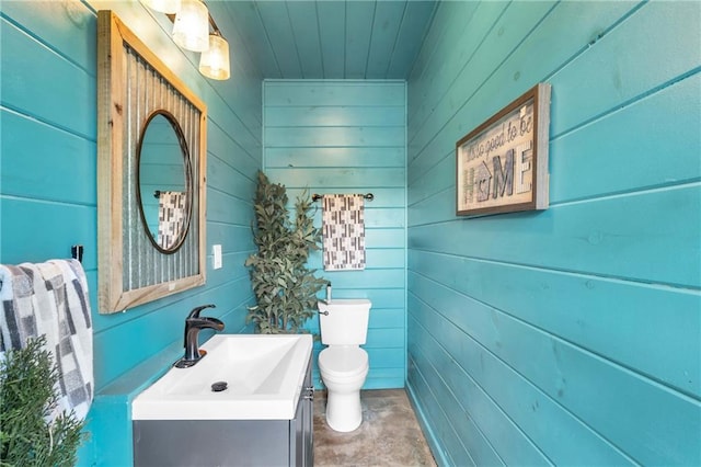 1580 Loving Rd, Morganton, GA 30560 - half bathroom featuring vanity, wooden walls, wooden ceiling, and toilet