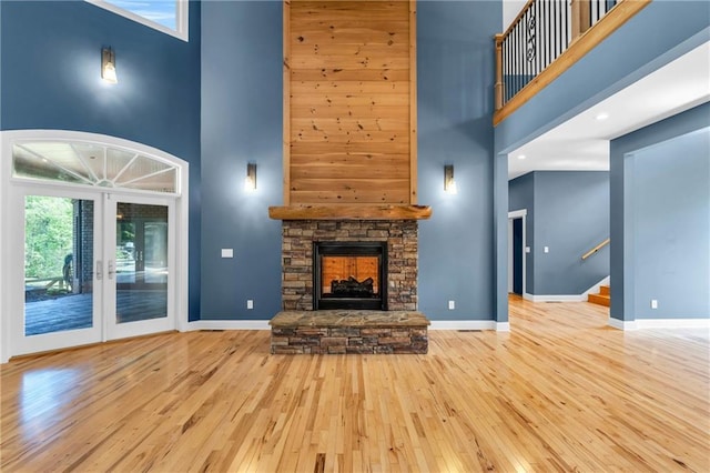 1580 Loving Rd, Morganton, GA 30560 - unfurnished living room with stairway, baseboards, hardwood / wood-style floors, and a towering ceiling