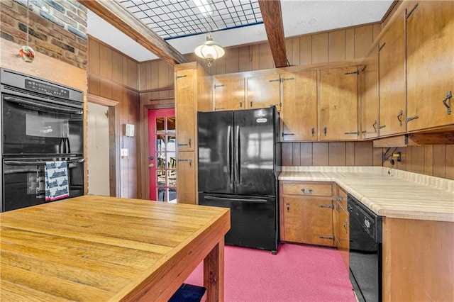 kitchen with carpet flooring, wood walls, and black appliances