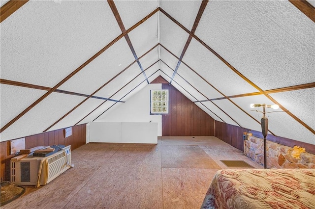 bonus room featuring vaulted ceiling and wooden walls