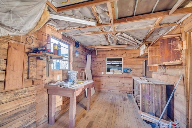 interior space with wooden walls and hardwood / wood-style floors